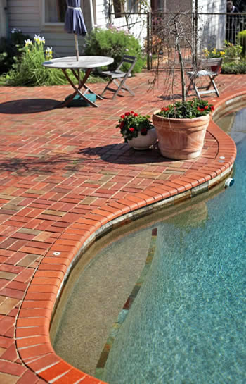Custom residential swimming pool with brick tiles
